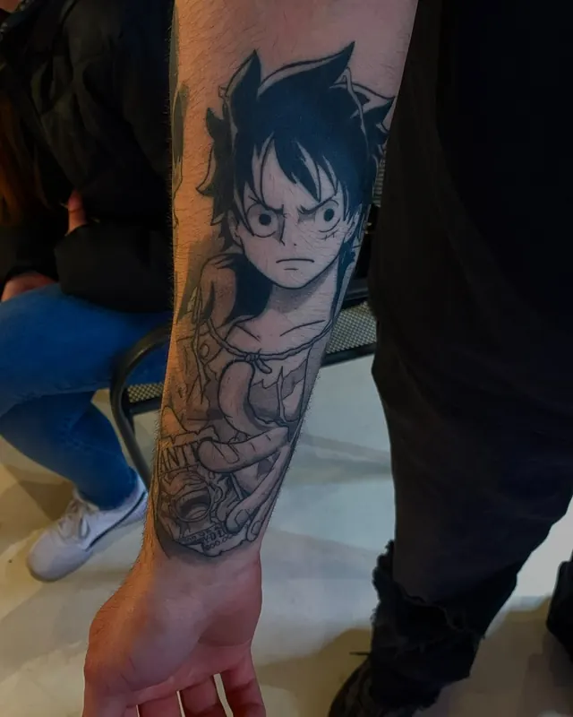 Werk van Niklo: anime-tattoo op de onderarm